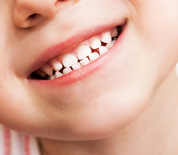 Close-up of a child’s white, healthy smile