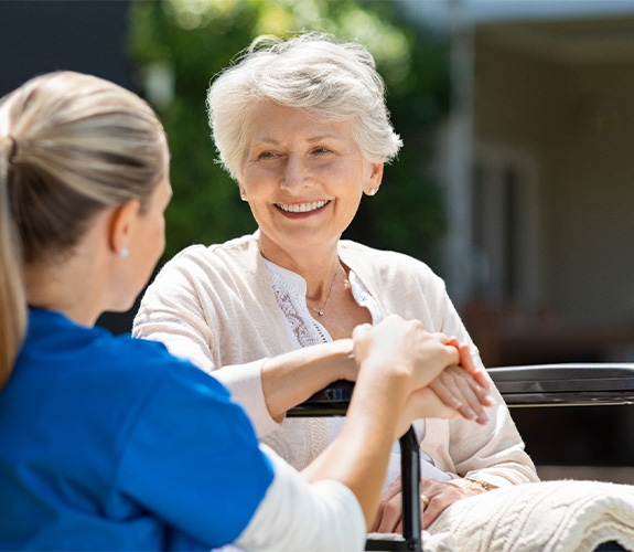 Older woman experiencing the benefits of dentures in Wilmington