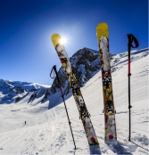 Skis and ski poles stuck in snow