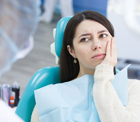 Patient discussing the cost of treating dental emergencies with her dentist