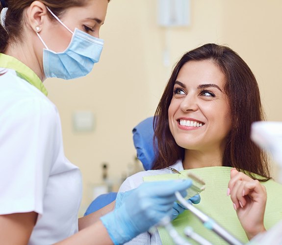 Woman discussing dental implants in Wilmington