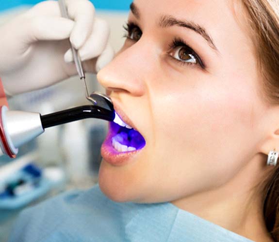 Woman receiving tooth-colored fillings in Wilmington