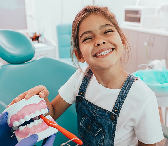 Little boy sitting in dental chair for Age One Visit in Wilmington, IL