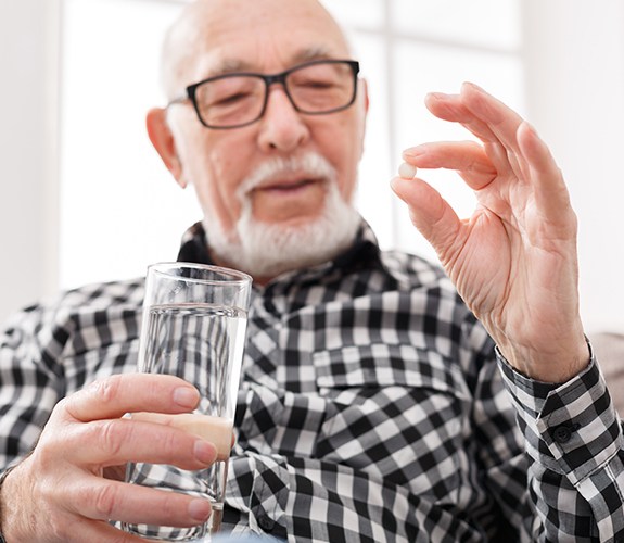 Man holding oral conscious sedation dentistry pill