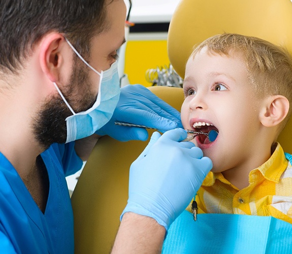 Boy smiling with dentist in Wilmington