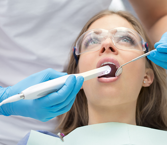 Dentist capturing images using intraoral camera