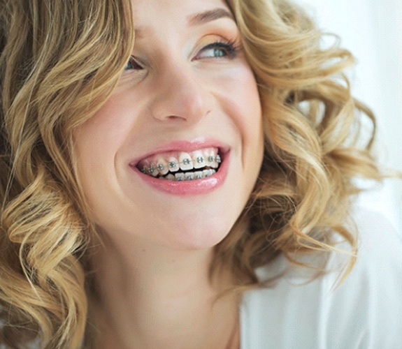 Close-up of smiling woman with traditional braces in Wilmington